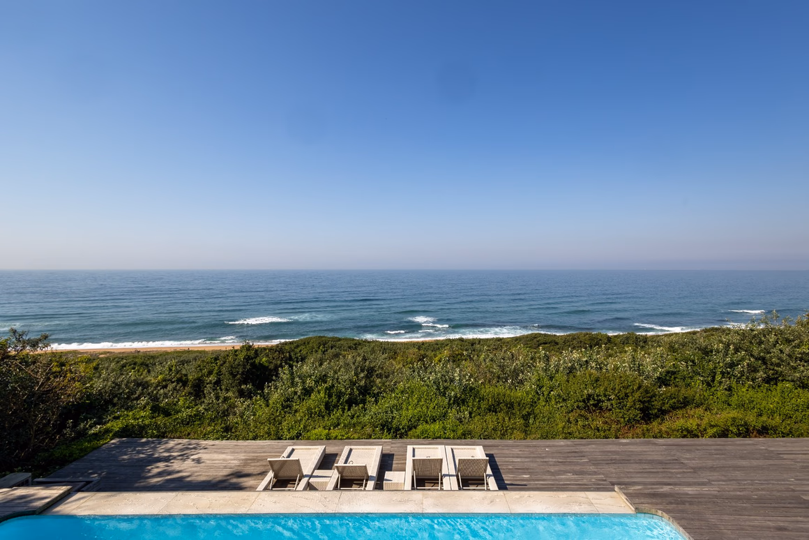Ocean and coastal forest outlook from the pool terrace at 12 Milkwood Street