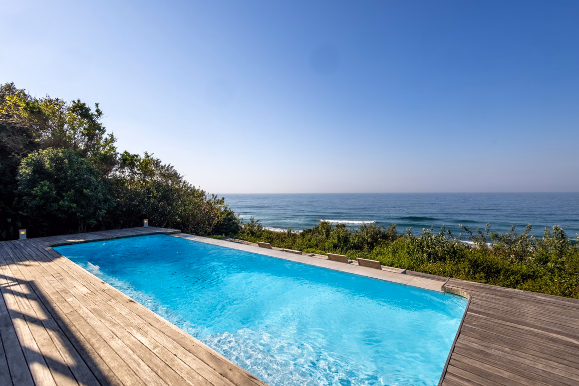 Timber pool deck overlooking the coastal forest and Indian Ocean in Zimbali Estate